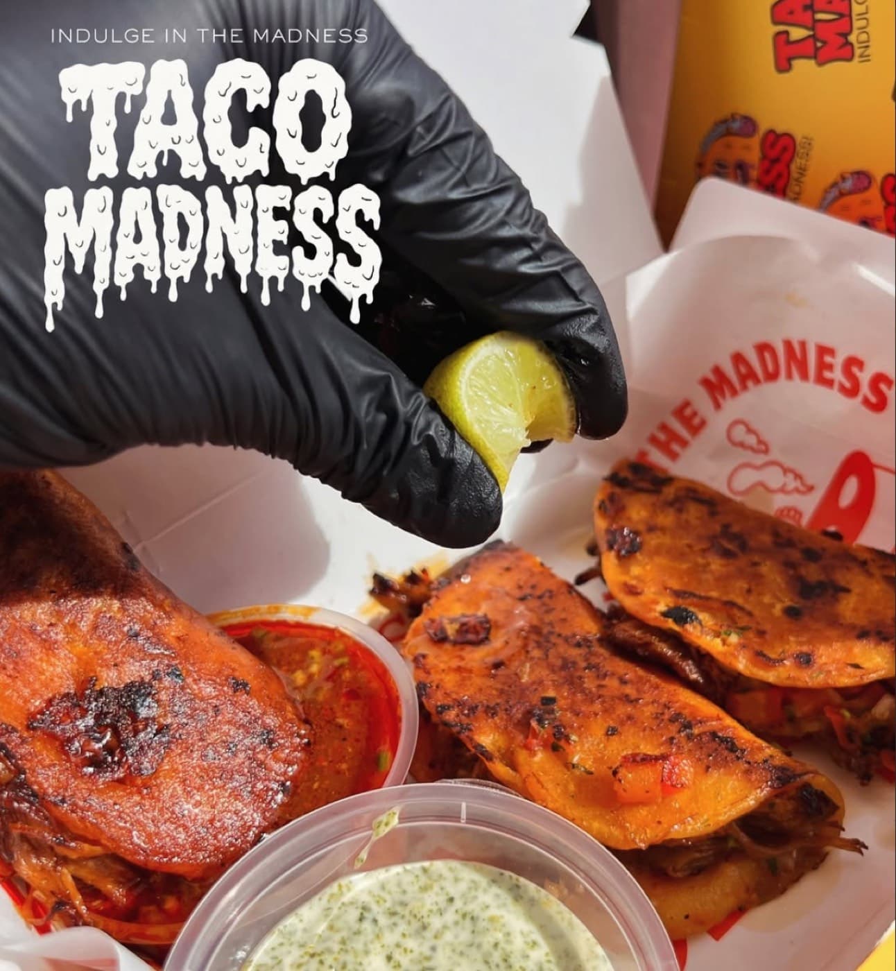 Squeezing lime over fresh birria tacos